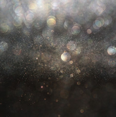 glitter vintage lights background. gold, silver, and black. de-f