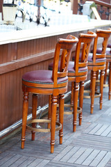 Street bar chairs in row, outside
