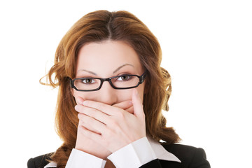 Businesswoman covering her mouth because of shame
