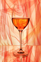Red wine glass of wine on bright background