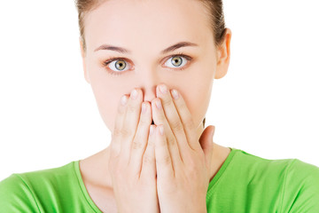 Student woman covering her mouth because of shame