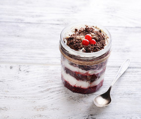 Delicious dessert in jar on table close-up