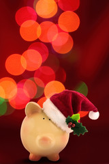 Christmas Piggy bank Santa with festive bokeh background