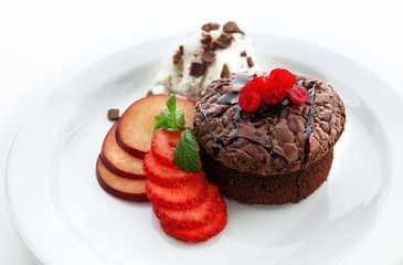 Hot chocolate pudding with ice-cream and fruits, close-up