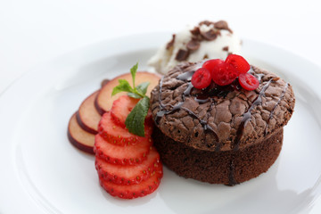 Hot chocolate pudding with ice-cream and fruits, close-up