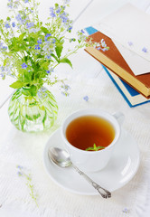 Herbal tea with flowers on wooden background