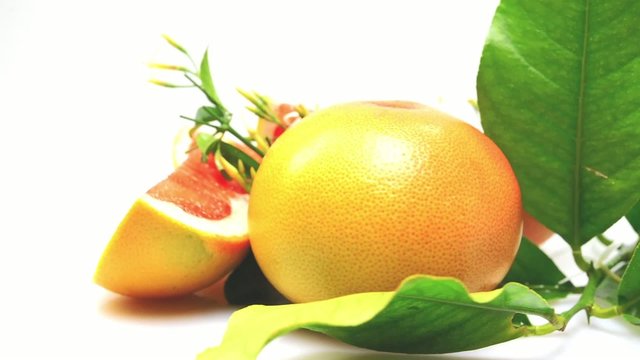 Orange and grapefruit rotating on white background