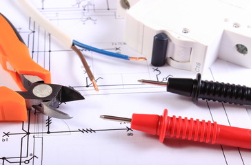 Cables of multimeter, pliers, electric fuse and wire on  drawing