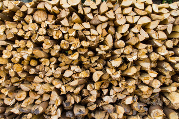 Background of a small pile of firewood logs stacked more.