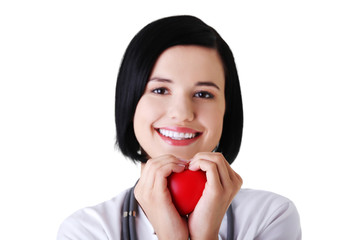 Portrait of female doctor holding heart model