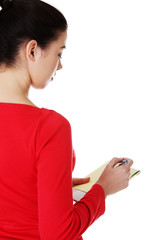 Woman writing notes and planning her schedule