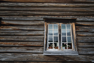 Obraz na płótnie Canvas Dark timbered wooden wall with white window