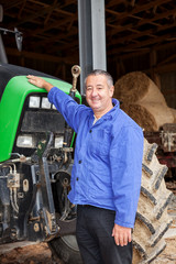 Farmer standing in front of his tractor