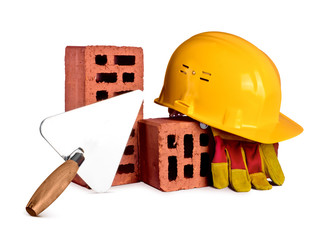 bricks, trowel and helmet on white isolated background