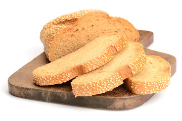 sliced loaf of bread on a cutting board isolated on white