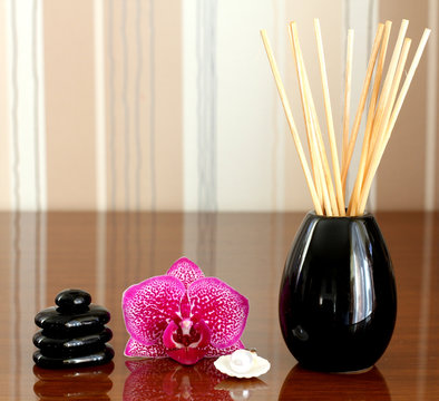 orchid and black stones close up.
