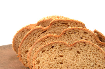 sliced loaf of bread on a cutting board isolated on white