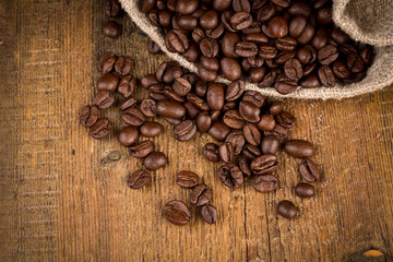 Coffee beans on grunge wooden background