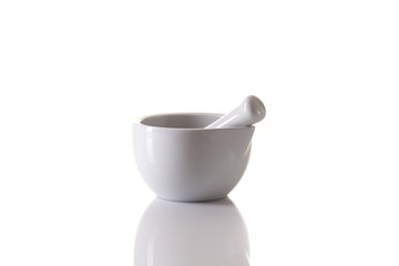 white porcelain mortar and pestle set on white
