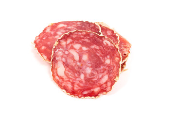 Slices of salami sausage on a white background