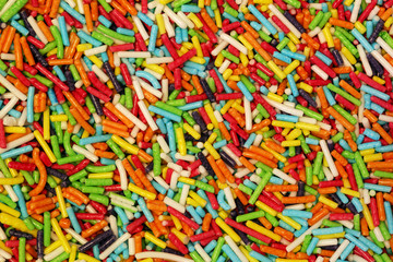 Fototapeta na wymiar Colorful small sweet sugar sticks decoration background