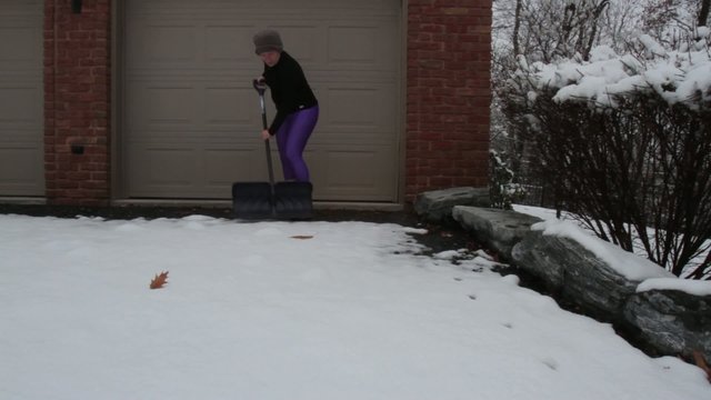 Woman Shoveling Snow