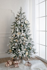 Christmas tree with presents underneath in living room