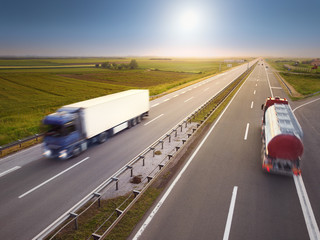 Two trucks in motion blur on highway