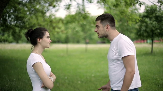 Young couple having fight in summer park slow motion