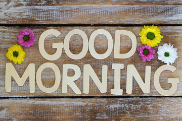 Good morning written with wooden letters and santini flowers