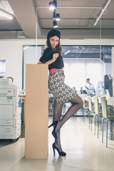 Beautiful young brunette posing in an office