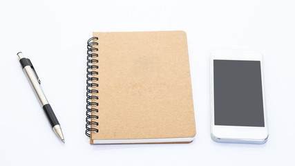 Mobile phone notebook and pen on white background