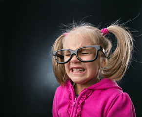 Scared little girl in funny big spectacles