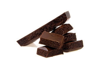 Porous dark chocolate on a white background, close-up