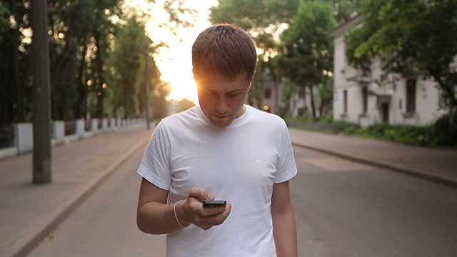 Man walks with smartphone slow motion