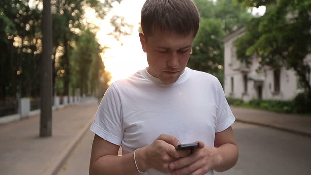 Man walks with smartphone slow motion
