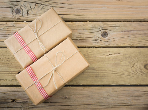 parcels  wrapped in brown paper and string with red check ribbon