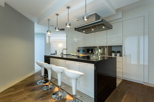 Contemporary kitchen with designer chairs