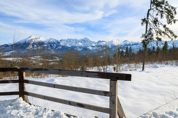Wooden fence in winter with view of Tatra Mountains, Poland