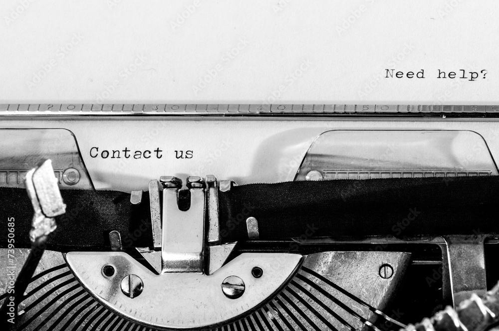 Fototapete typewriter; contact us and need help? text typed on a paper
