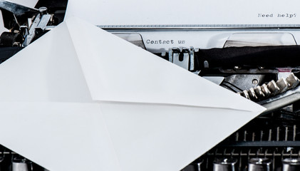 Typewriter; Contact us and Need help? text; envelope