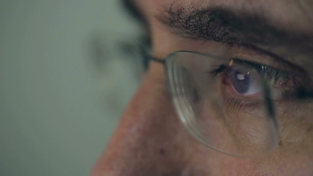 Close up middle-aged man working on a computer Macro lens