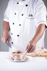 Obraz na płótnie Canvas Chef prepared cooking raw chicken