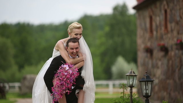 Newlyweds. Bride straddled Groom like a horse