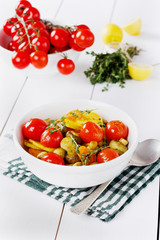 Baked potatoes with carrots, mushrooms and cherry tomatoes