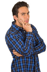 handsome young latin man wearing a blue plaid shirt posing