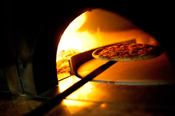 A pizza in a oven burning - 73958618