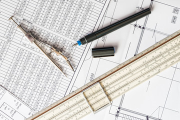 Slide rule with diagrams and drawing tools on the table