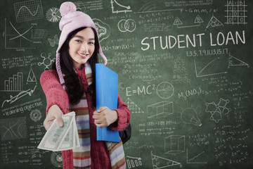 Schoolgirl in winter wear giving student loan