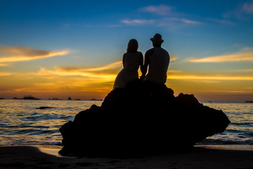 young loving couple on wedding day on tropical beach and sunset